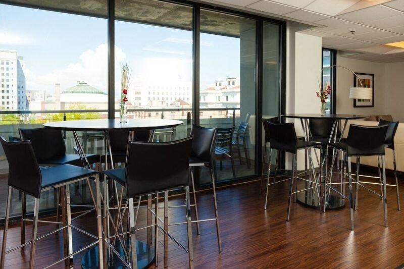 a large room with tables and chairs and a projection on the wall