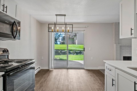 Apartments for Rent in Silverdale, WA - Ridgetop - Kitchen with Modern White Cabinets, Stainless-Steel Appliances, and Wood-Style Floors