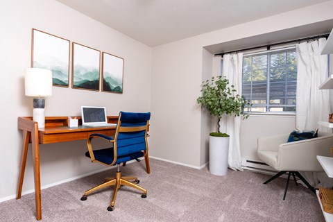 an office with a desk and a chair and a window