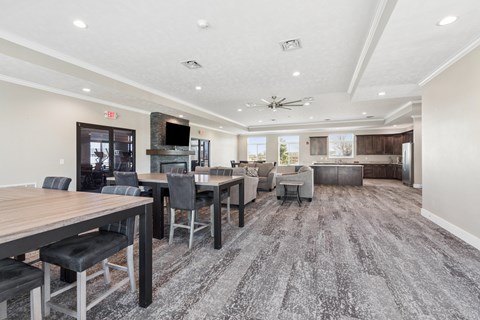 A spacious room with a long table and chairs.