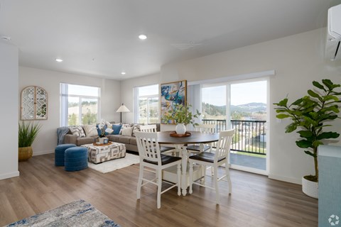 A dining room with a white table and chairs.