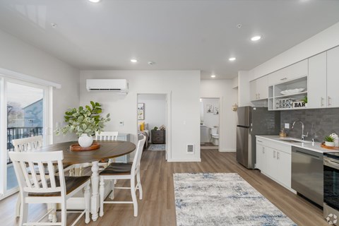 A modern kitchen with a dining table and chairs.