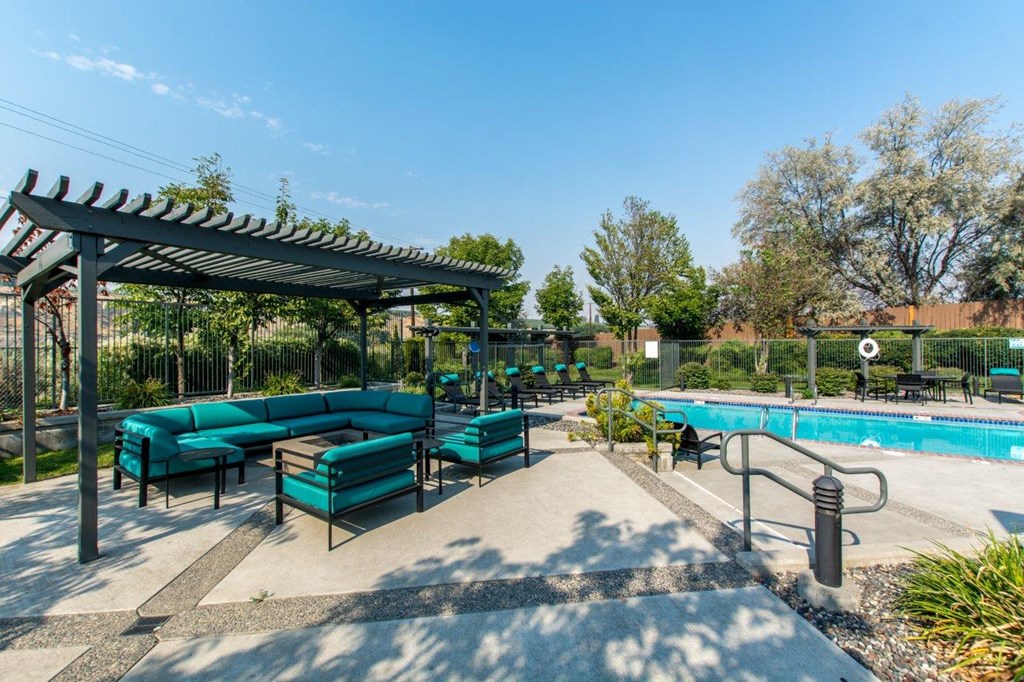 Riverpointe Apartments Pool with Lounge Chairs and Sofa