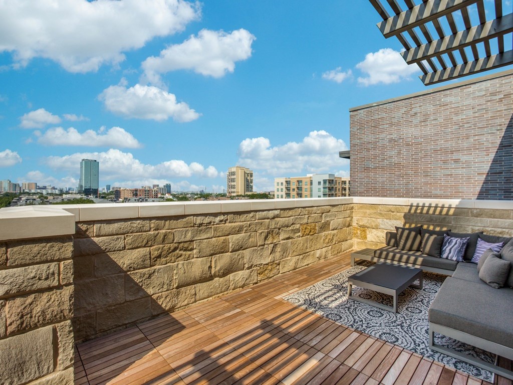 a roof deck with a view of the city