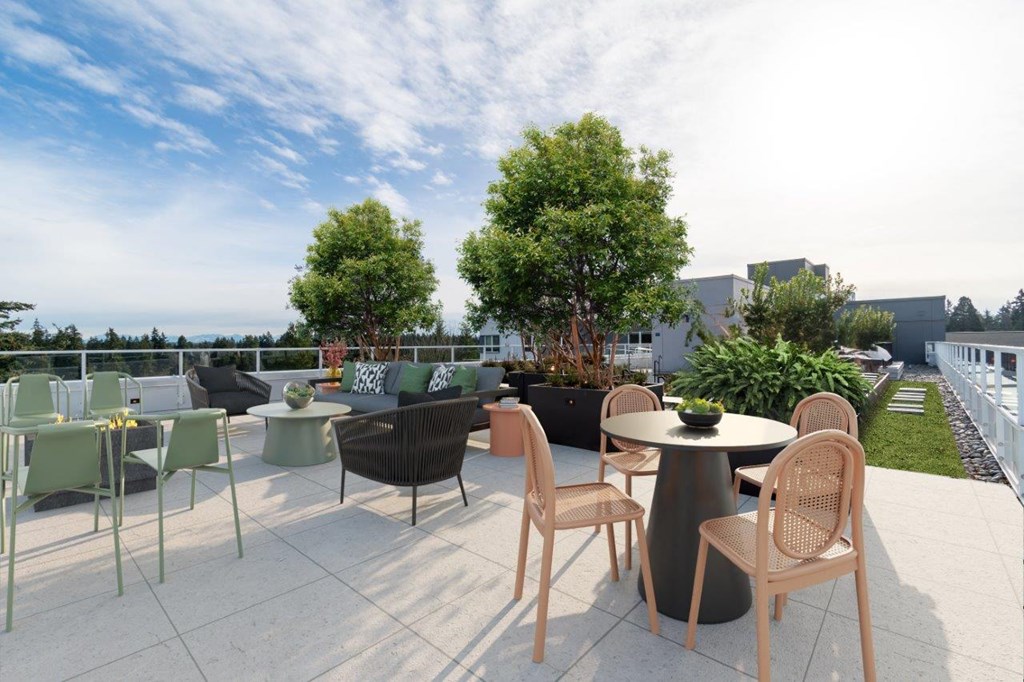 A patio with a table and chairs is set up on a rooftop.