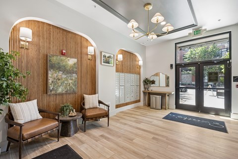 A waiting area with a wooden bench and a painting on the wall.