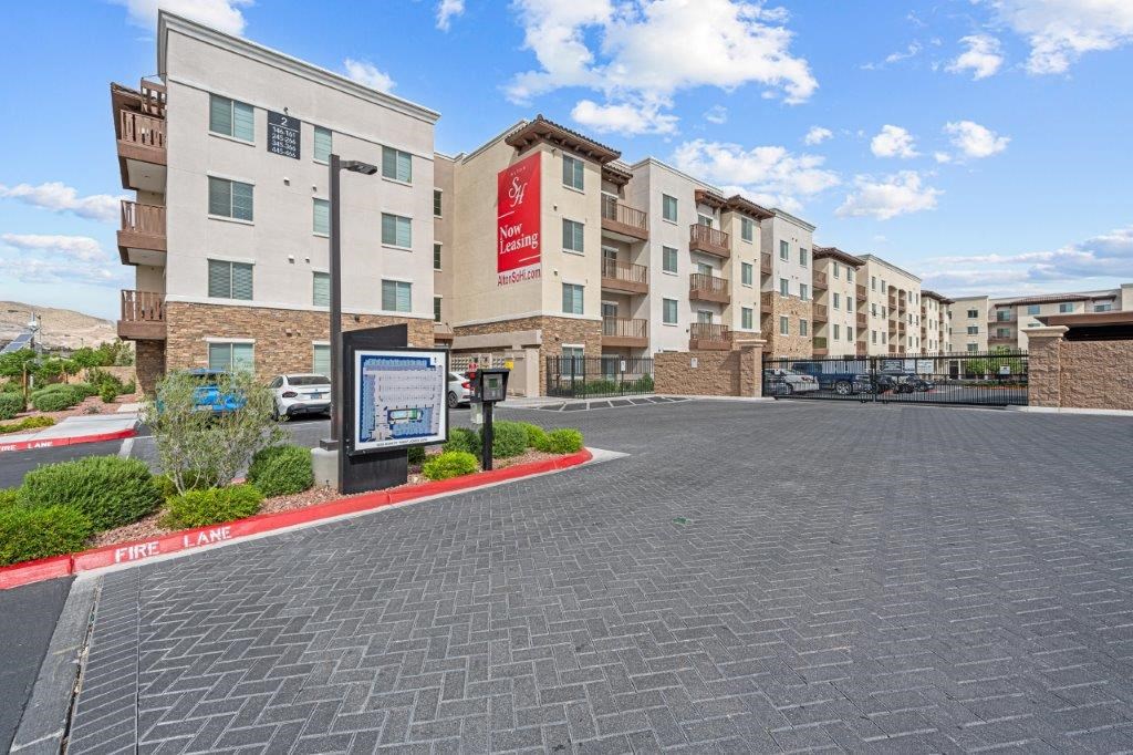 an empty parking lot in front of an apartment building