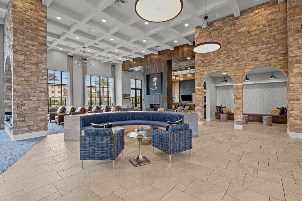 a lobby with couches and chairs and a fireplace