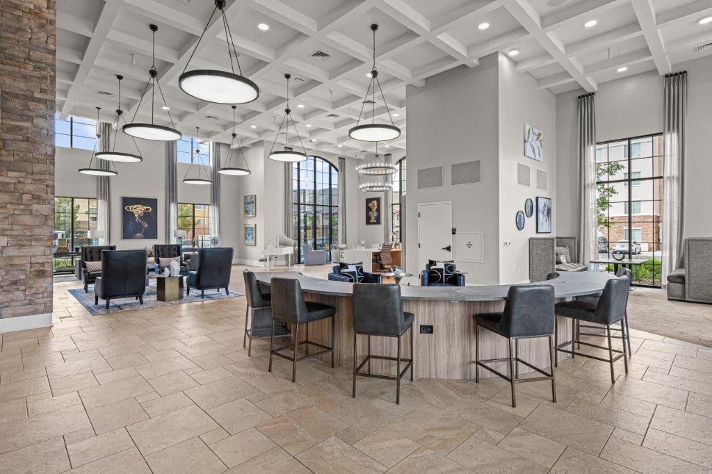 a clubhouse with a bar and dining area with chairs and tables