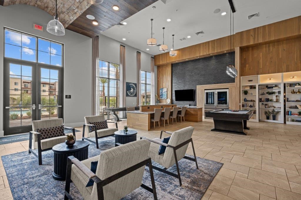 a living room with a fireplace and a table with chairs