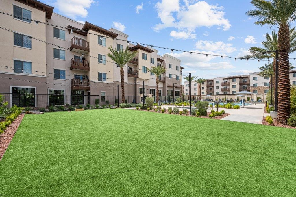 a lush green lawn in front of an apartment building
