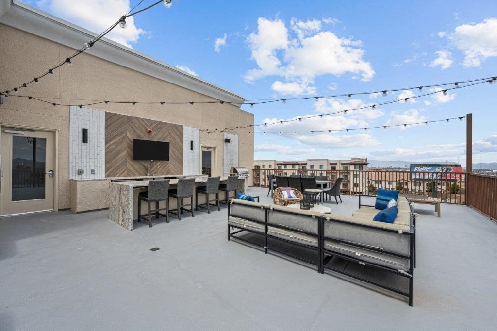 the patio of a building with a table and chairs and a bar