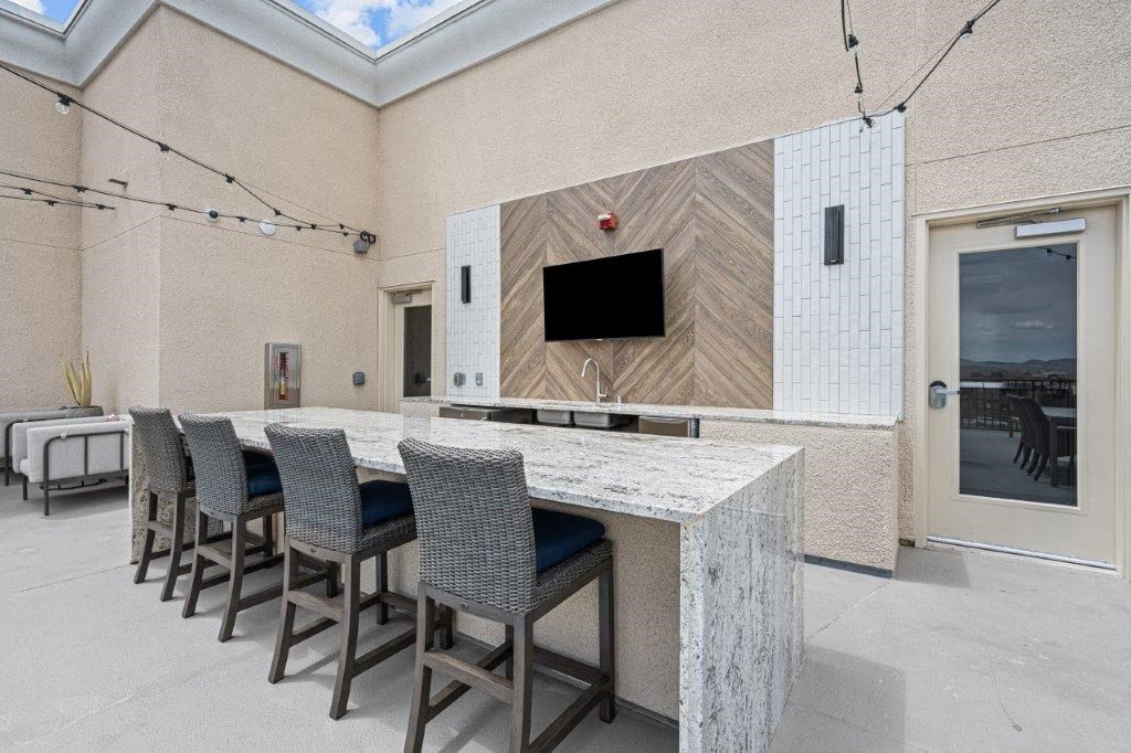 a kitchen with a marble counter top and a group of chairs