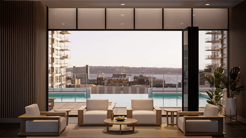 A modern living room with a view of the cityscape outside.