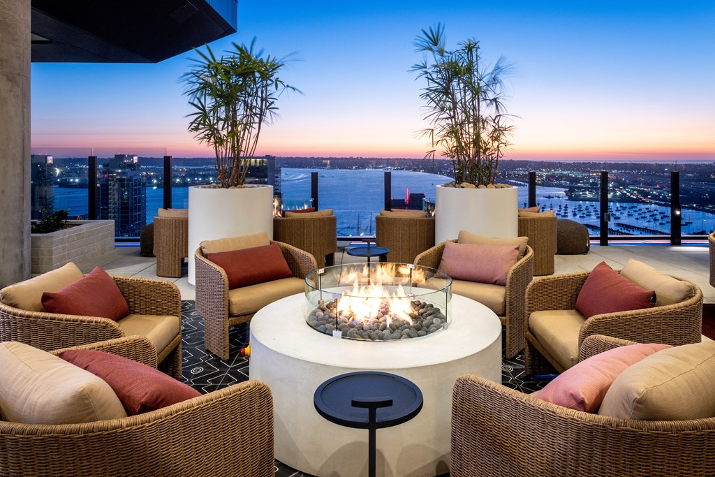 Simone seating area with a fireplace and a view of the city at sunset