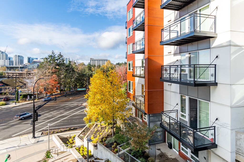 an aerial view of an apartment building overlooking a city street