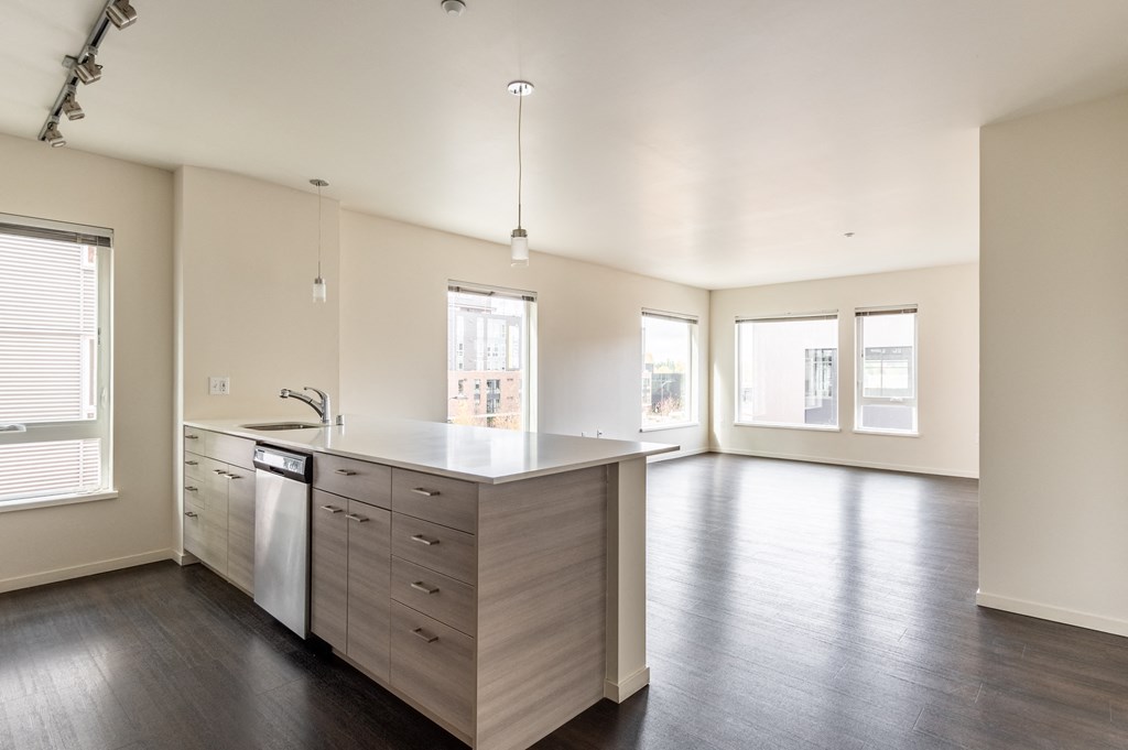 an empty kitchen with an island in the middle