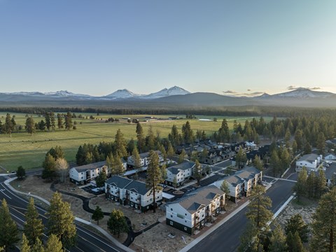 A housing development with a mountain range in the background.