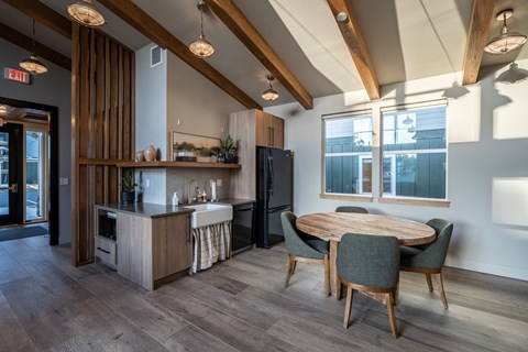 A kitchen with a table and chairs in the middle of the room.