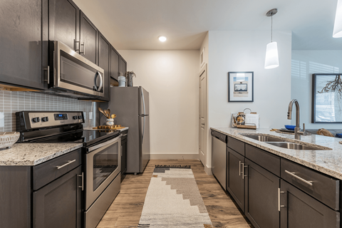 a kitchen with stainless steel appliances and granite counter tops