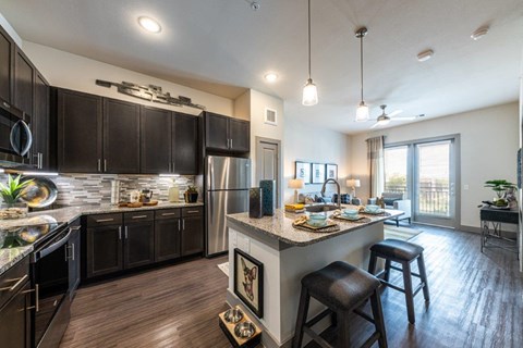 a kitchen and living room with a large counter top