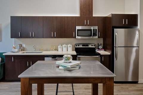 a kitchen with stainless steel appliances and wooden cabinets