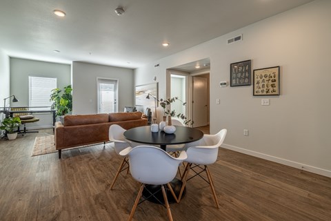 A dining room with a round table and chairs.