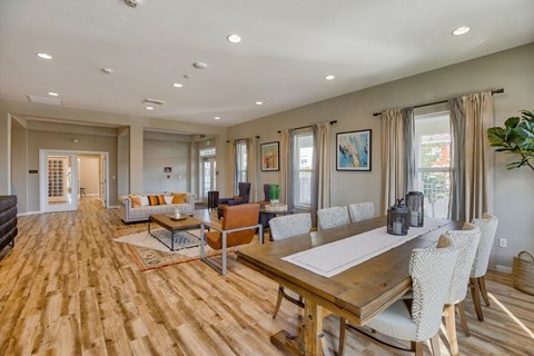 A dining room with a long table and chairs.
