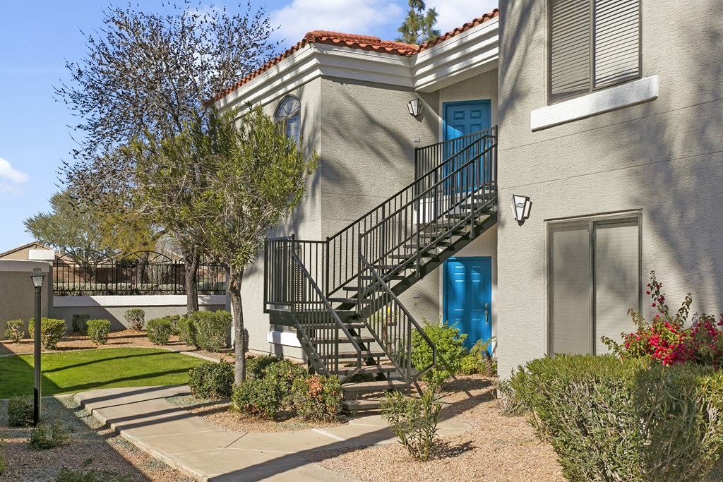 a building with a staircase and a blue door