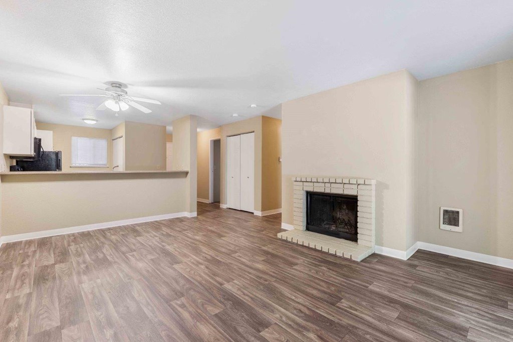 Saratoga Apartments in Everett, Washington Living Room with Fireplace and Kitchen