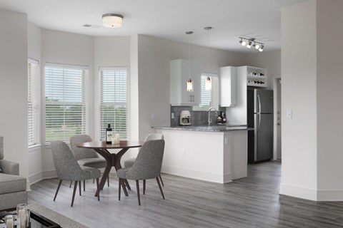 A modern kitchen with a dining table and chairs.
