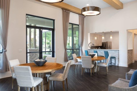 A modern dining room with a round table and chairs.