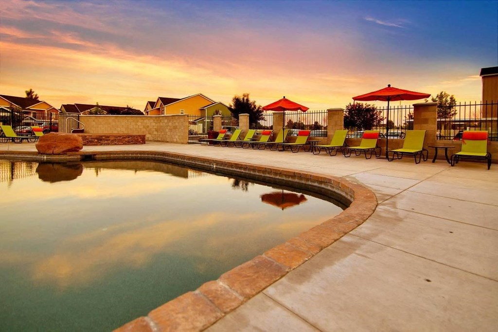 Selway Apartments in Meridian, Idaho Pool with Lounge Chairs at Dusk