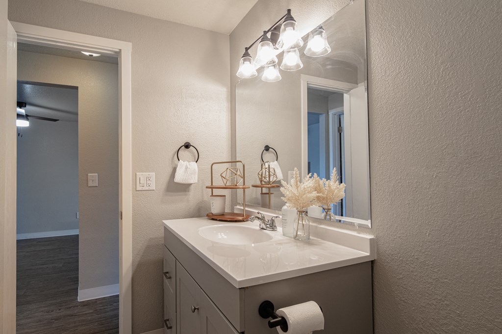 the guest bathroom has a large mirror and a white sink