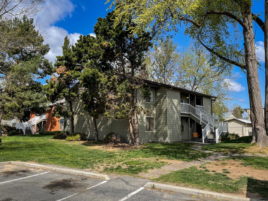a gray house with a yard and trees