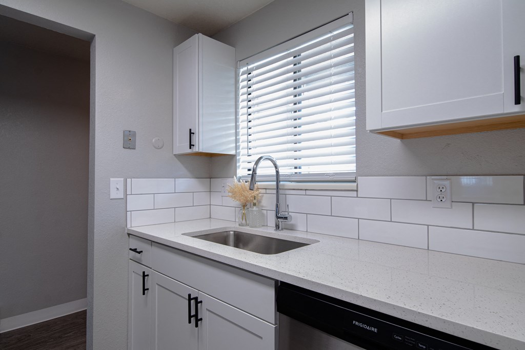 Shannon South Apartments kitchen with white cabinets and a sink