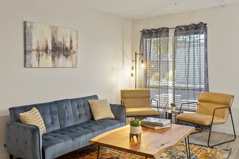 a living room with a couch and chairs and a coffee table