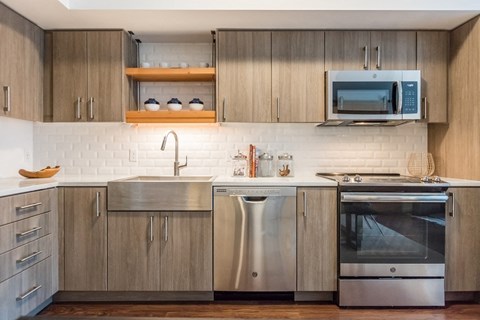 a kitchen with stainless steel appliances and wooden cabinets