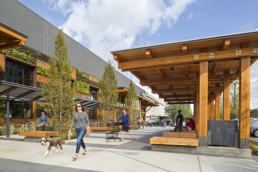 a woman walking a dog in front of a building