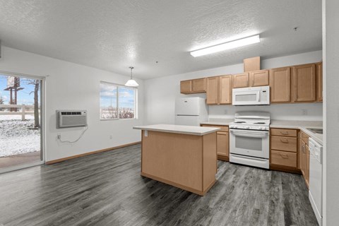 A kitchen with wooden cabinets and a white stove top oven.