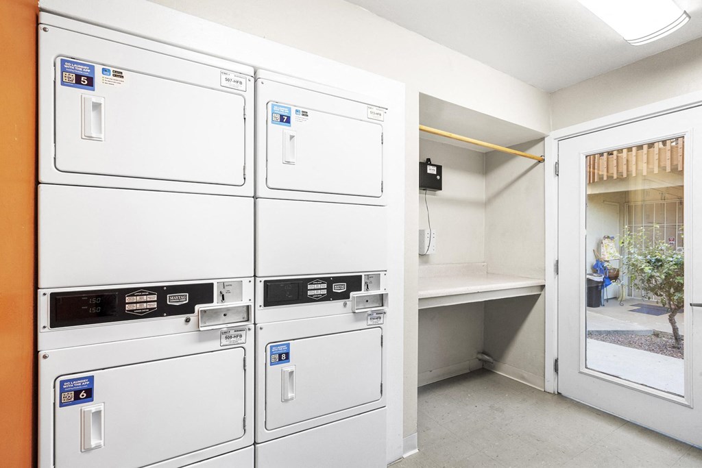 A row of washing machines in a laundry room.