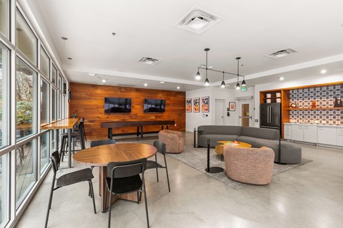 A modern dining area with a wooden table and chairs.