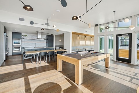 A modern kitchen with a dining table and chairs.