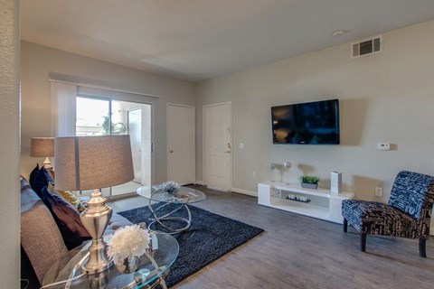a living room with a couch and a table and a television