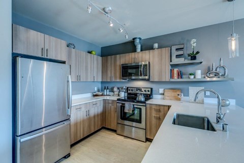 a kitchen with wooden cabinets and stainless steel appliances
