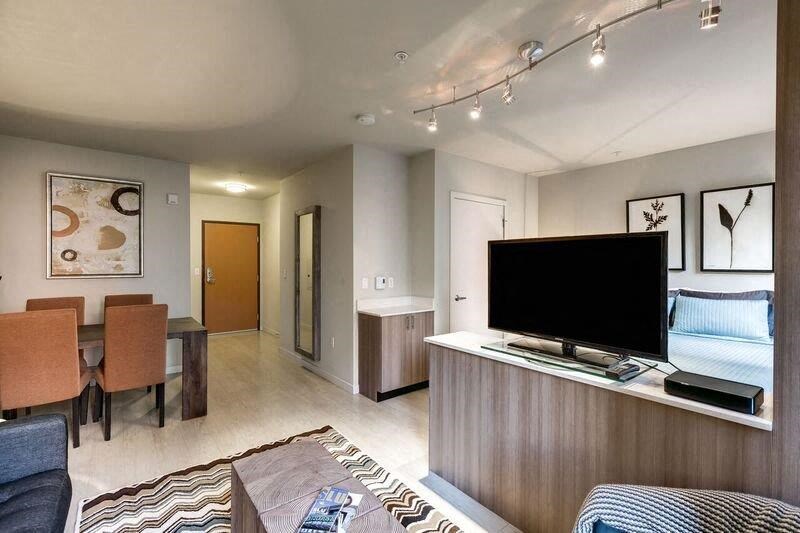 a living room and dining room with a television