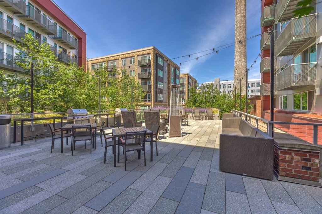 a rendering of a patio with tables and chairs