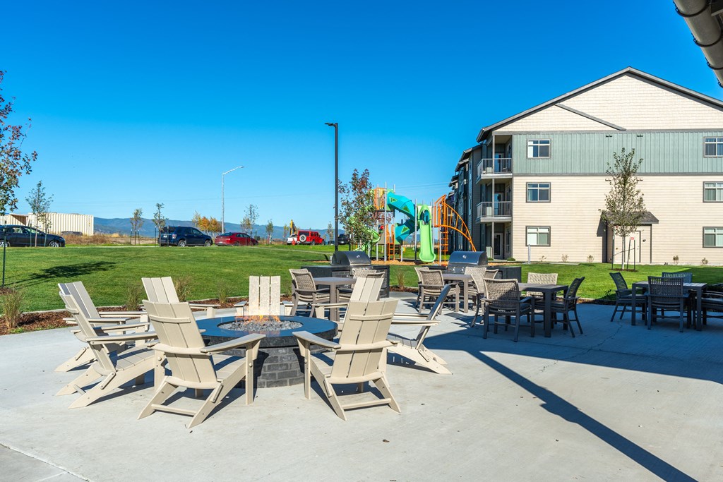 Stillwater Crossing  Apartments Exterior patio with firepit and chairs