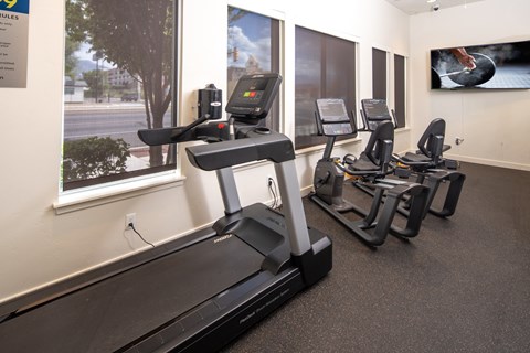 A gym with treadmills and exercise bikes.