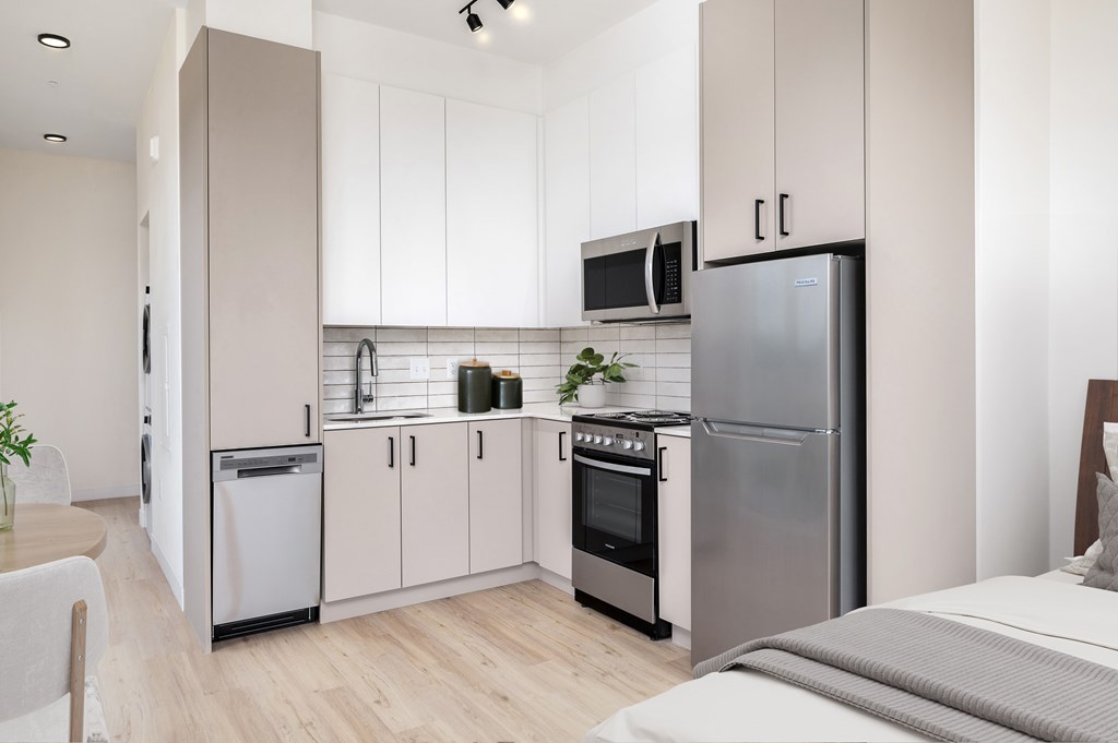 MERX Slabtown kitchen with a white fridge, sink, and cabinets.